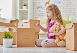 young girl with moving boxes